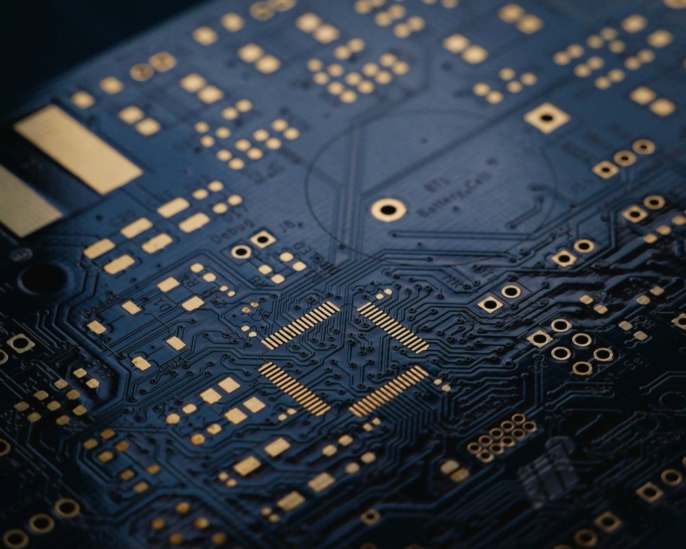 A blue circuit board photographed close up