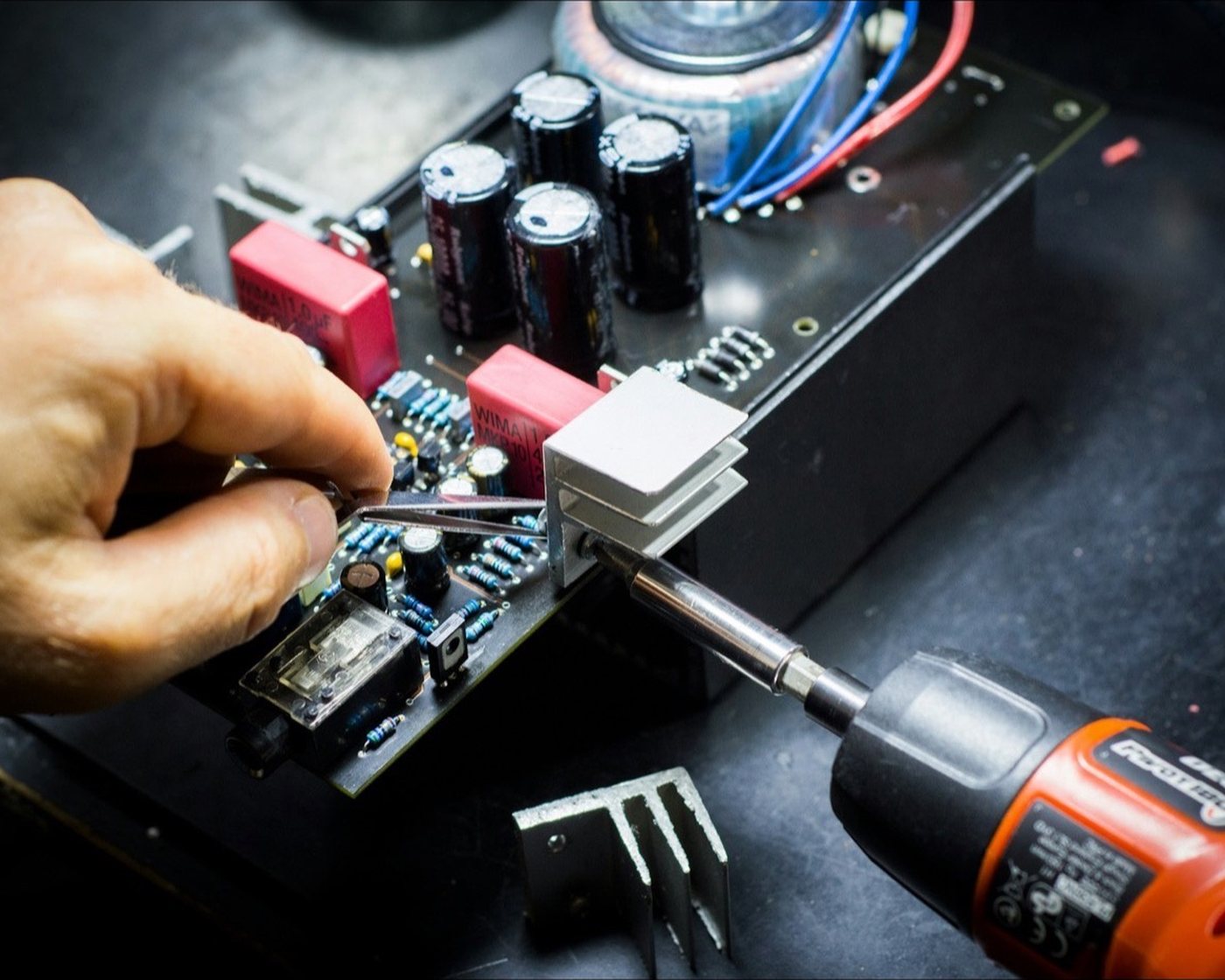 A black circuit board on a dark background